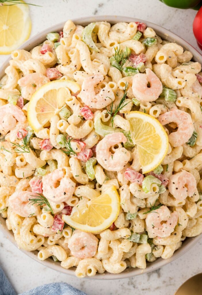 A large bowl of this macaroni salad with shrimp and veggies.