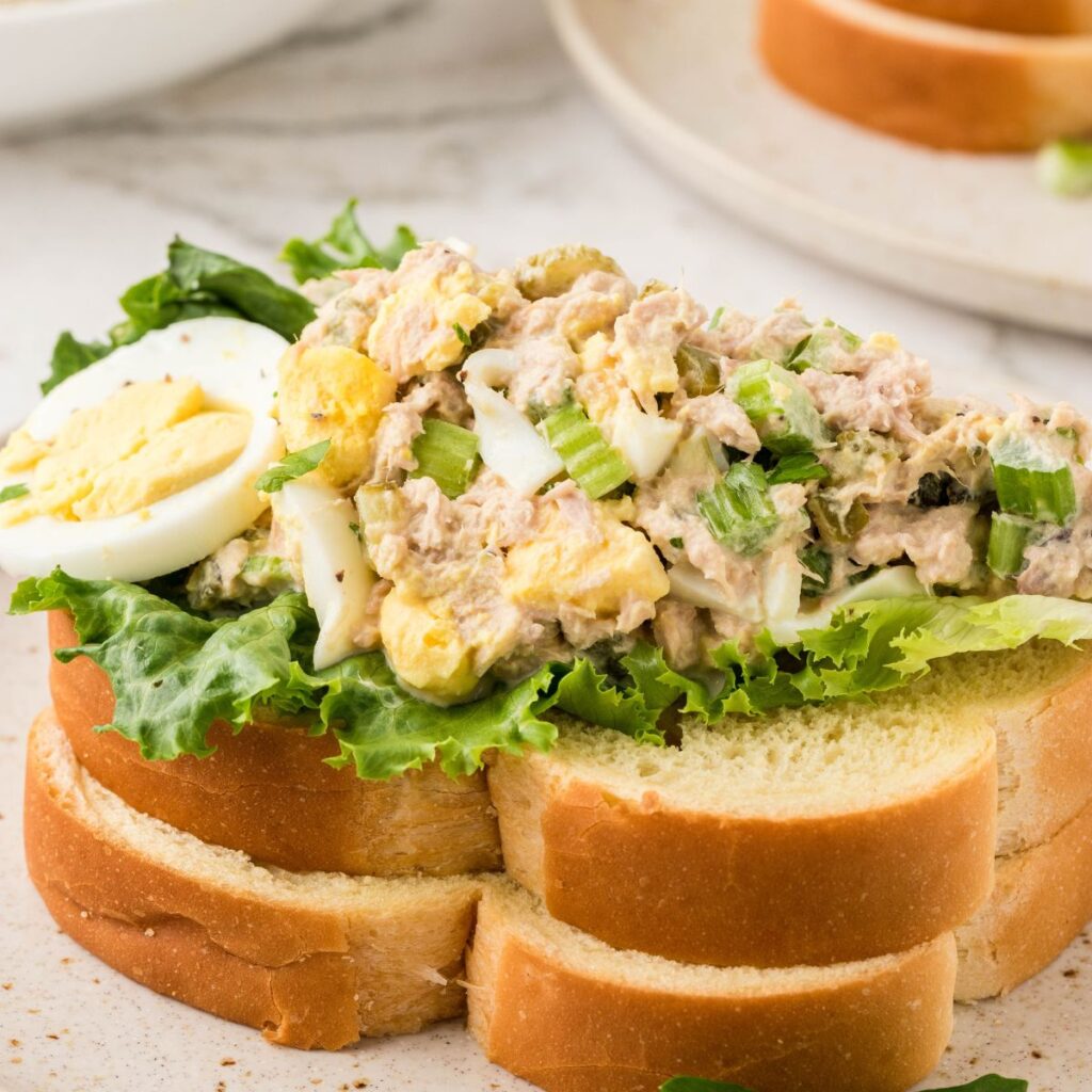 Tuna salad served on a piece of bread with lettuce. 