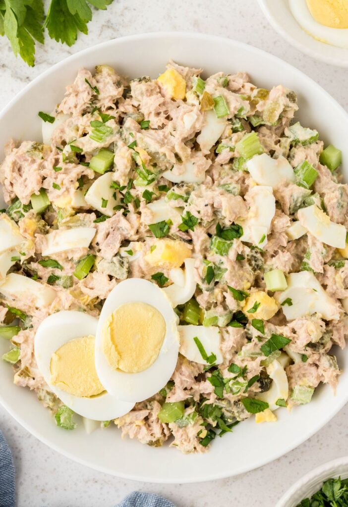 Overhead of a white bowl of this salad recipe with tuna and egg. 