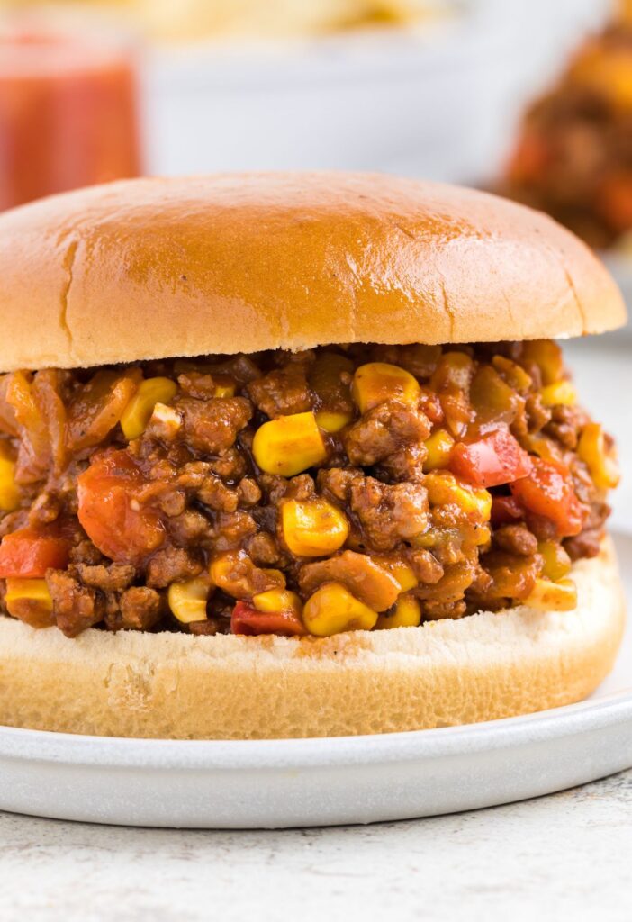 A sloppy Joe filled with ground beef mixture on a plate. 