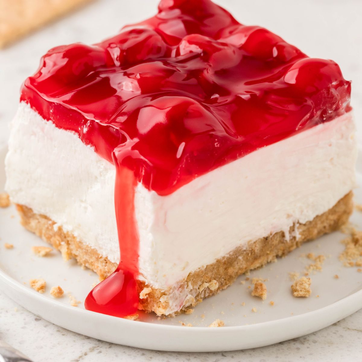 A piece of this layered dessert on a white plate.