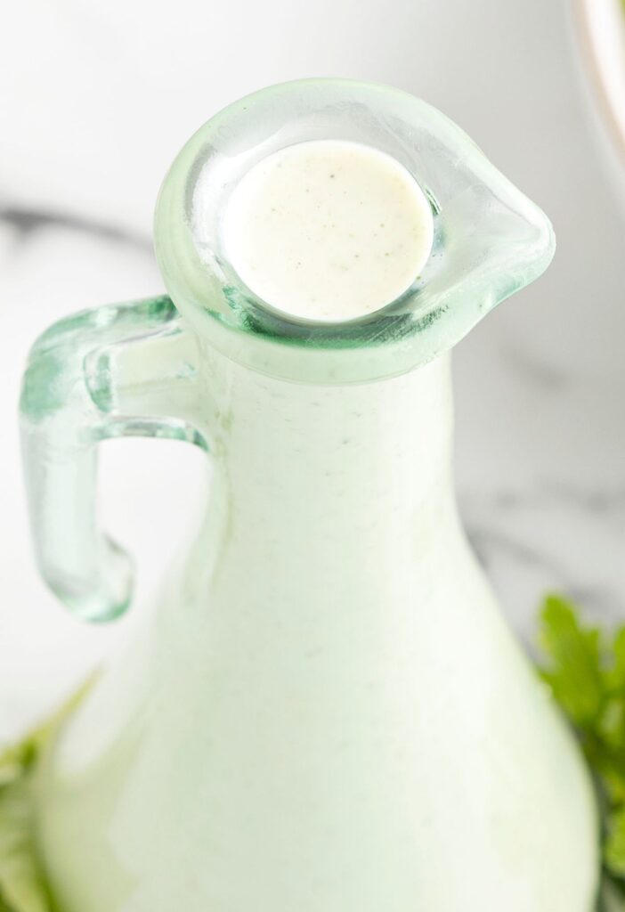 A glass container of ranch dressing