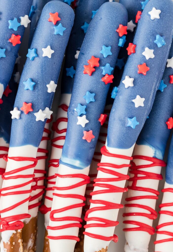 Close up shot of the pretzel rods decorated with red white and blue. 
