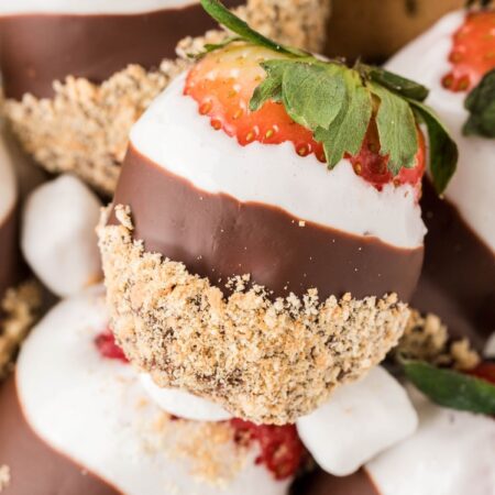 A pile of dipped strawberries in marshmallow and chocolate.