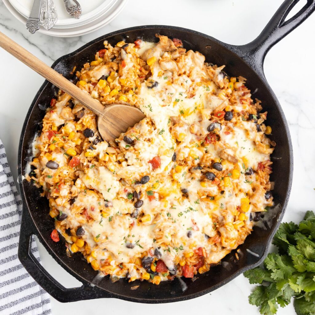 A skillet pan of taco rice with cheese. 