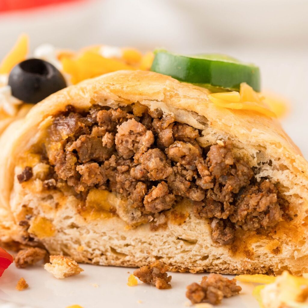 Inside of a cut taco ring showing the meat inside. 