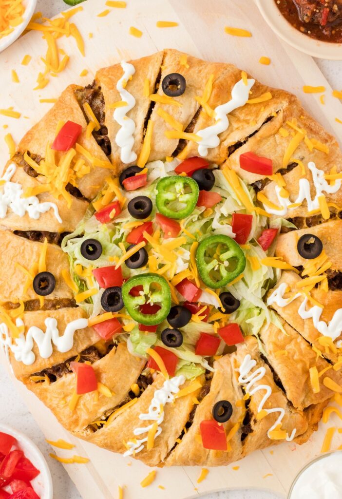Overhead picture of the ring of taco meat and dough with toppings. 