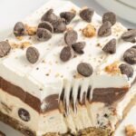A slice of this layered lush dessert topped with mini chocolate chips.
