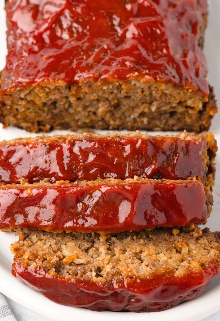 Cut slices of meatloaf with a ketchup glaze. 