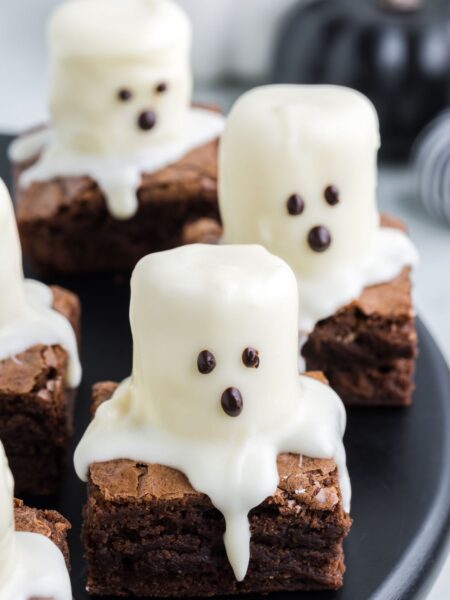A brownie square with a marshmallow ghost on top.