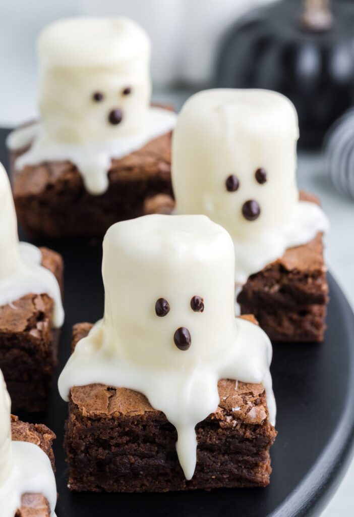 A brownie square with a marshmallow ghost on top. 