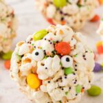 A popcorn ball decorated for a halloween party.