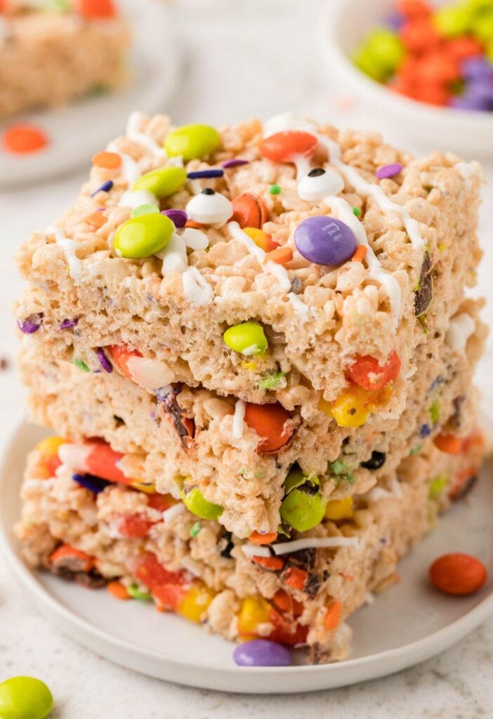 Stack of crispy cereal bars with candy. 