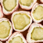 Close picture of cut slices of this appetizer recipe with pickle and ham.