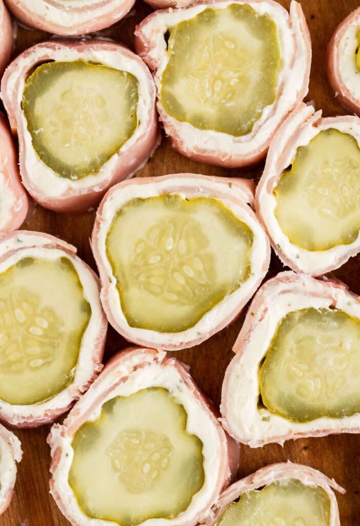 Close picture of cut slices of this appetizer recipe with pickle and ham. 