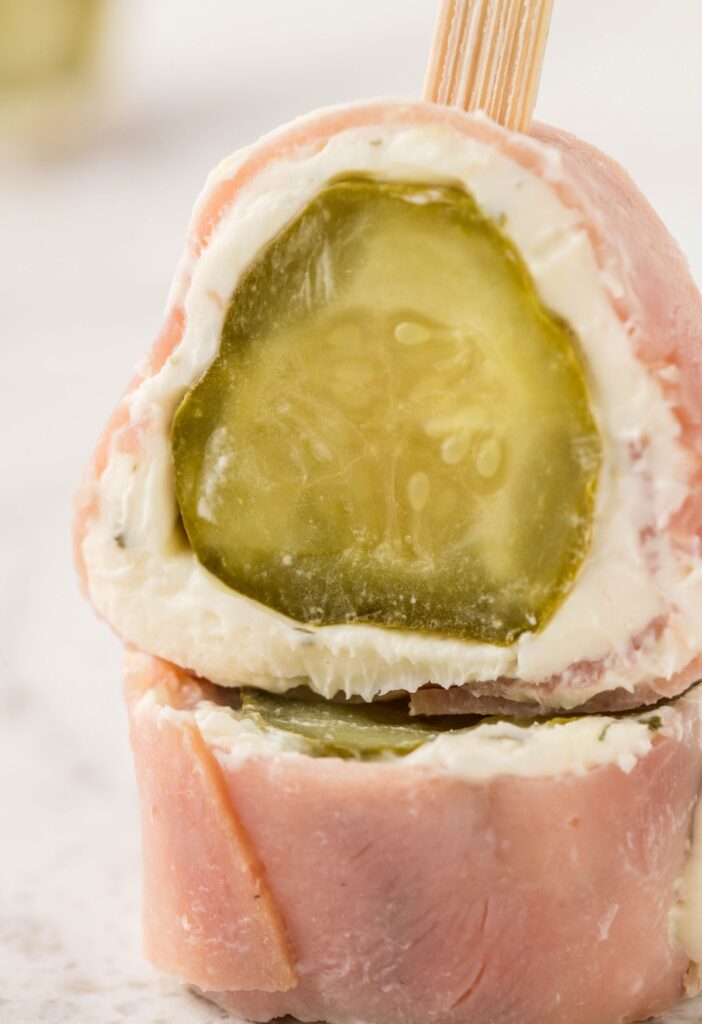 Stack of these ham and pickle roll ups with a skewer stick in them. 