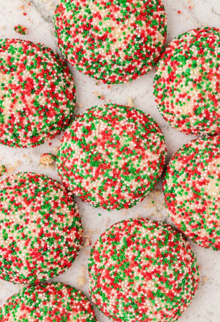 Cookies on a white background with red and green christmas sprinkles. 