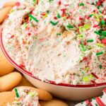 Cake dip with some taken out of it with Nilla wafer cookies.