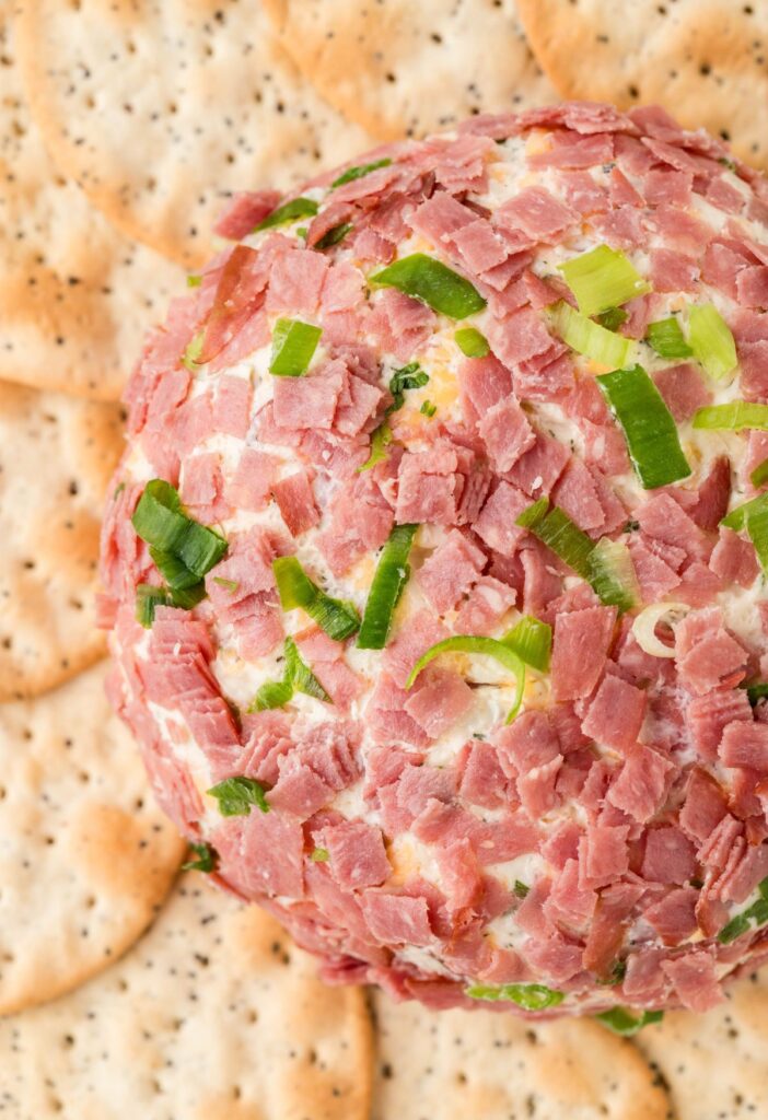 Overhead photo of a cheeseball covered in dried beef. 