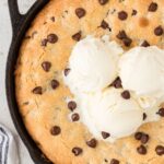 A skillet cookie topped with ice cream.
