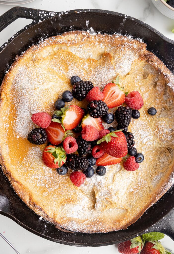 Dutch baby pancake in a skillet pan that has been cooked. 