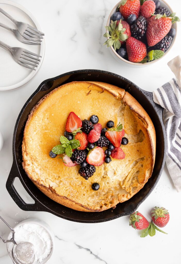 A cooked dutch pancake with berries