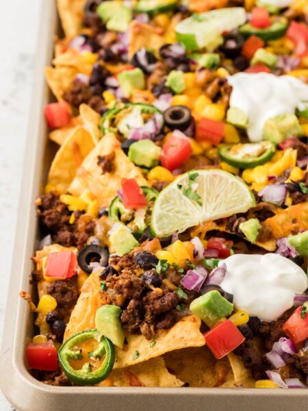 A side view of the sheet pan of nachos
