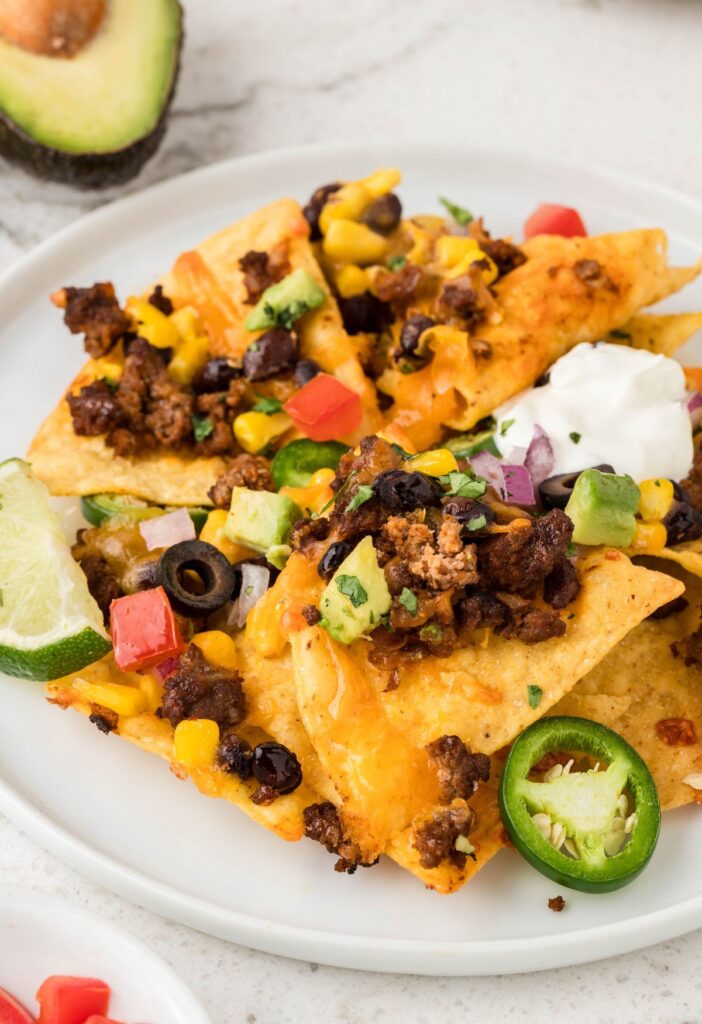 Plate of nachos with toppings