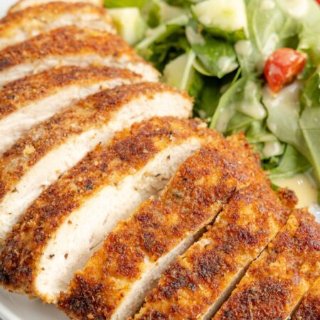 Cut chicken breast that is crispy and pan fried.