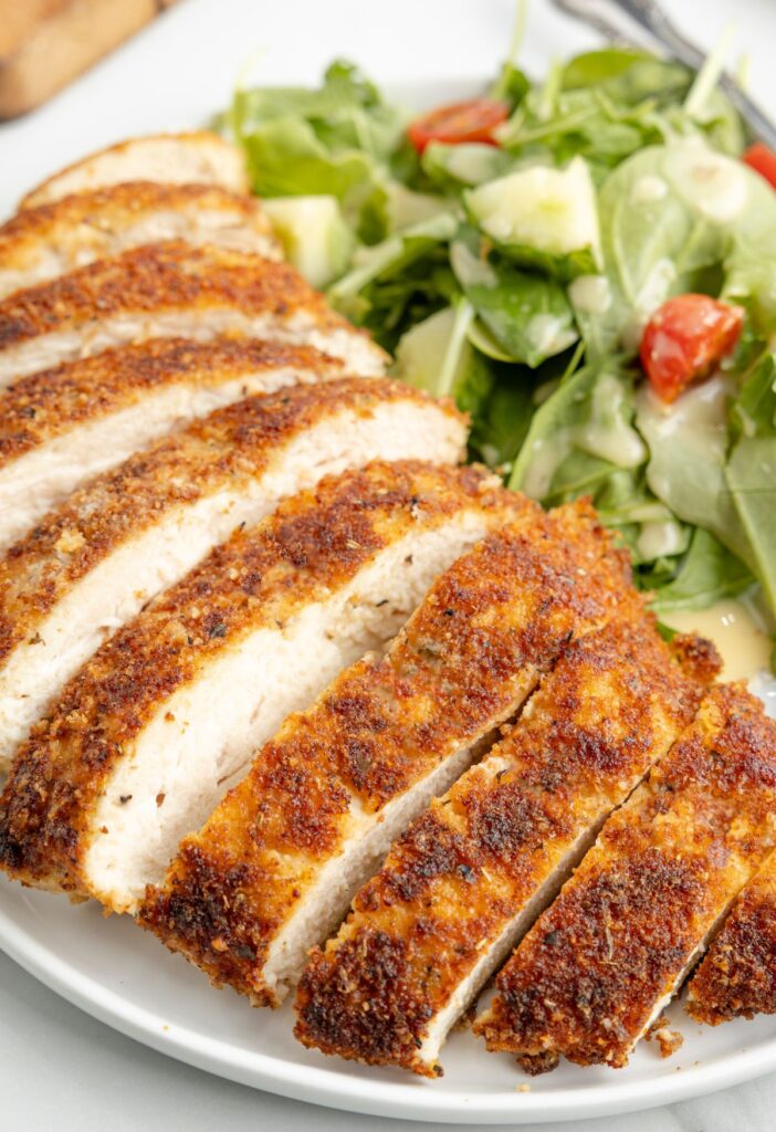 Cut chicken breast that is crispy and pan fried. 