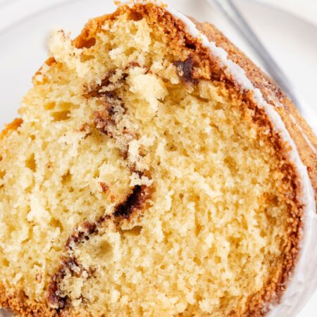A slice of the cinnamon bundt cake with a cinnamon swirl in the center.