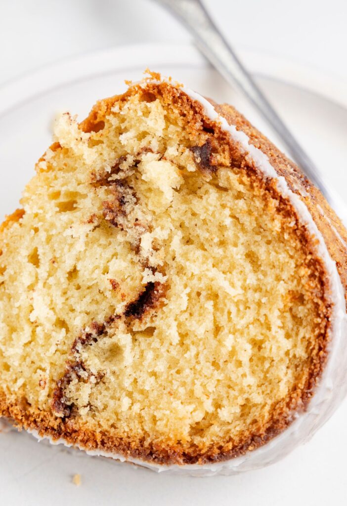 A slice of the cinnamon bundt cake with a cinnamon swirl in the center. 