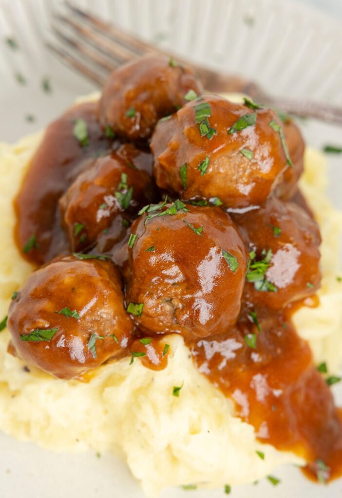 A serving of frozen meatballs with gravy 