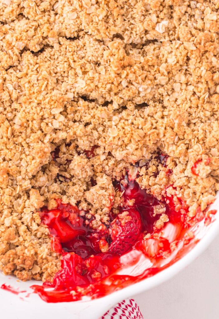 A baking dish of crumble with some taken out to see the middle. 