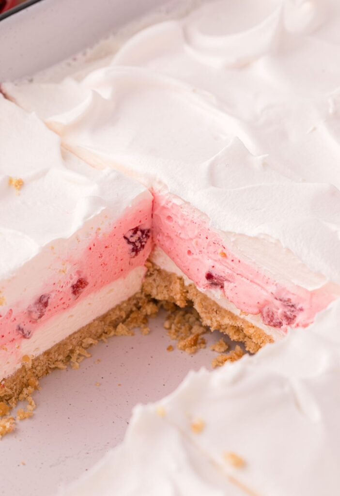 A pan of layered dessert with a slice taken out to show the layers in the center. 