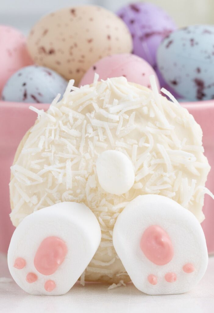A bunny butt cookie with coconut and marshmallows on it. 