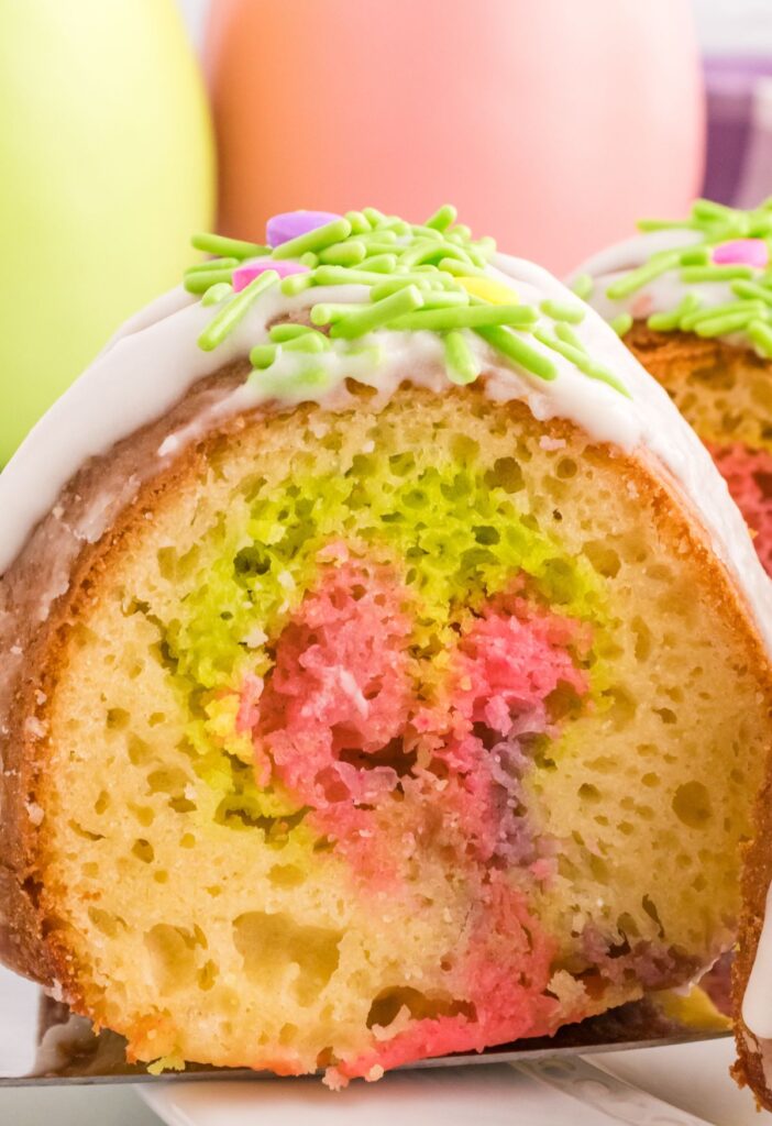 A slice of easter cake with color swirls in the center. 