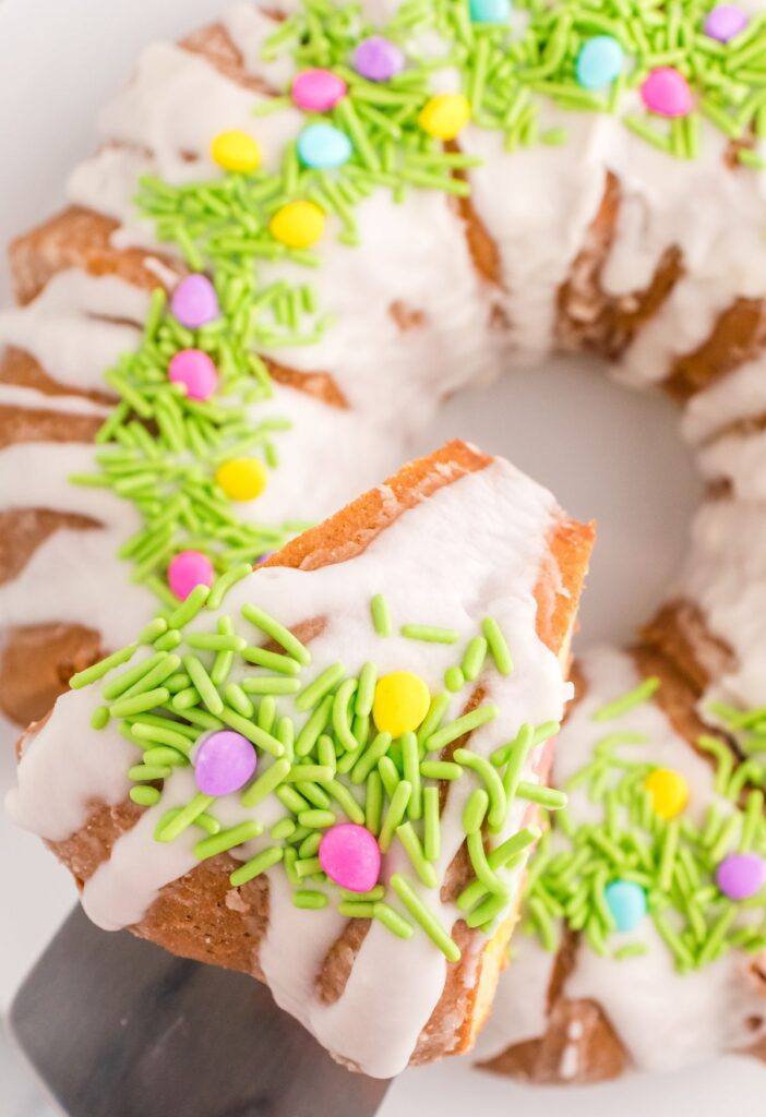 Top view of the frosted bundt cake with easter themed sprinkles. 