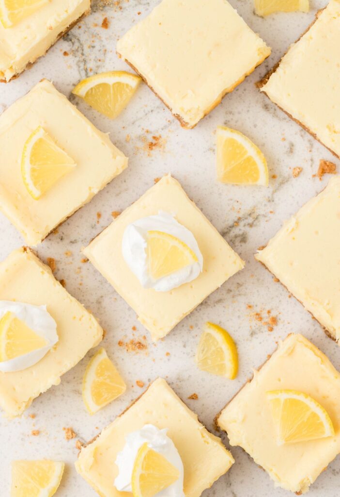 Cut bars with lemon and whipped cream as garnish. 