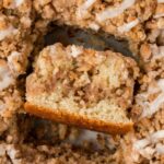 A pan of coffee cake with one slice turned on its side.
