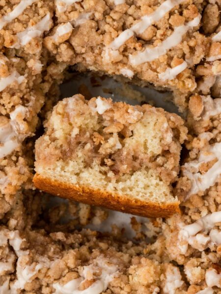 A pan of coffee cake with one slice turned on its side.