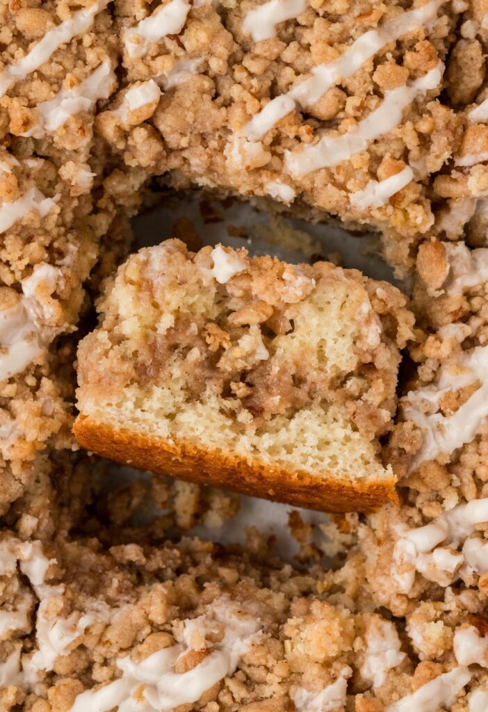 A pan of coffee cake with one slice turned on its side. 