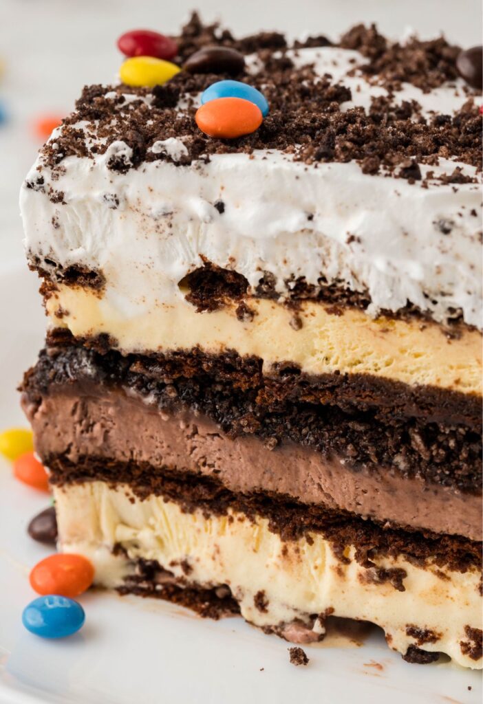 A slice of ice cream sandwich cake on a white plate.