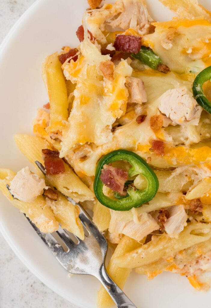A serving of the chicken and pasta casserole with a fork. 