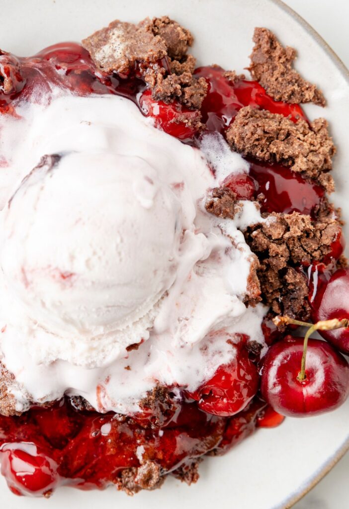 A serving of dump cake with ice cream on top