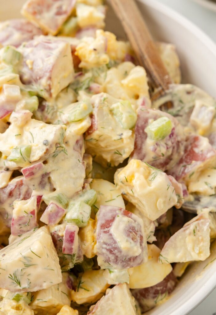 A serving bowl of the potato salad side dish