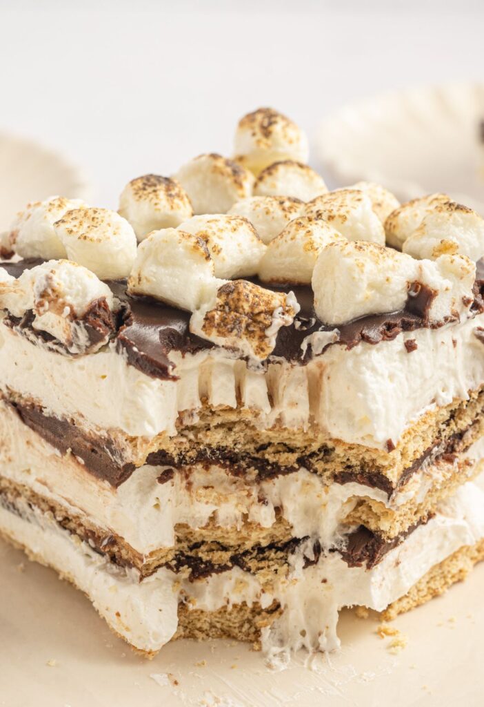 A slice of the s'mores cake with a fork bite taken out of the front. 