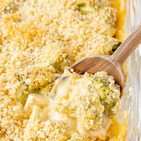 The baked casserole with a serving spoon in the baking dish.