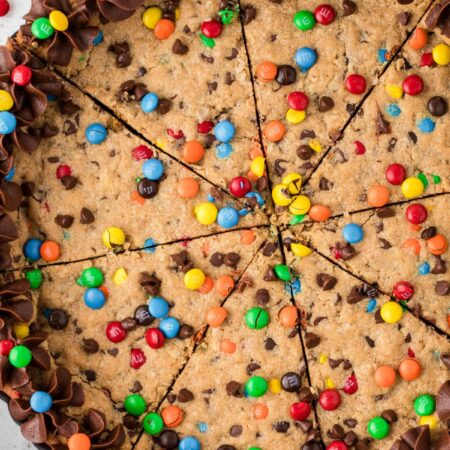 A giant cookie with chocolate frosting and m&m's