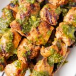 The grilled skewers on a white plate